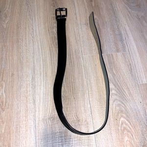 Woman’s black faux leather large silver belt